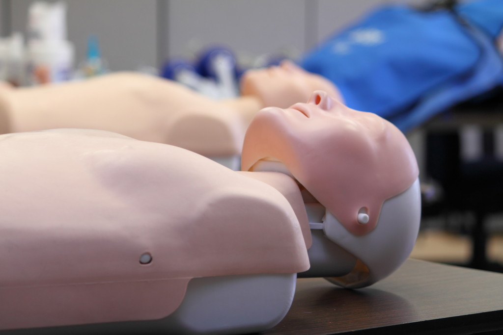 CPR training dummy in a classroom on a table.